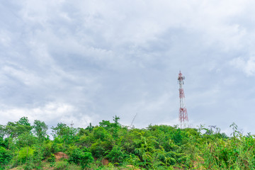 Telephone tower Internet signal The red color on the mountain top With a blue sky background With dense clouds