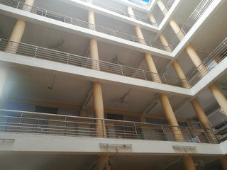 Long pillars of a building from ground to top having multiple floors.