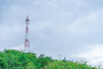 Telephone tower Internet signal The red color on the mountain top With a blue sky background With...