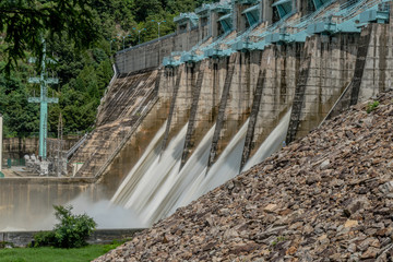 Obraz premium Water from reservoir rushing over spillway
