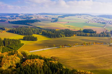 Fototapeta na wymiar Aerial autumn rural landscape with winding road, fields and forest