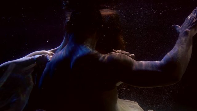 man and woman are having sex inside swimming pool, underwater shot of their sexual bodies