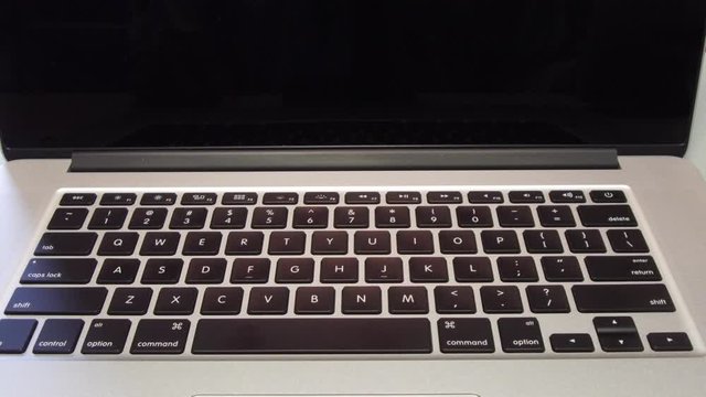 Man Typing the Letter C on Laptop Computer
