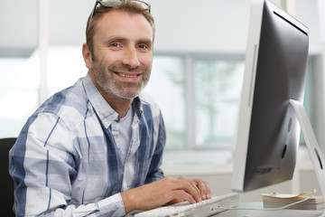 Fototapeta na wymiar happy man working with laptop from home