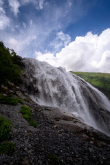 Beautiful powerful waterfall in the Caucasus Mountains.