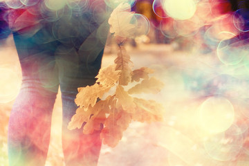 leaf fall autumn / fallen yellow leaves in the hands of a single girl walking in the park, concept autumn melancholy mood