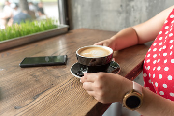 woman holding a cup of coffee. cup of coffee