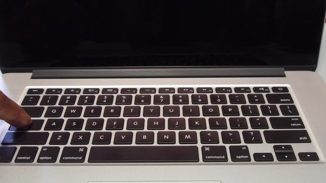 Man Typing the Caps Lock Key on Laptop Computer