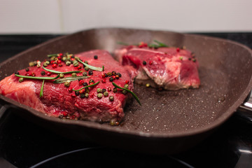 grilled beef steak with vegetables, seasoned with pepper and rosemary, close-up