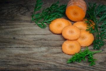 A wooden table with sliced carrots. Place for text. Background. Vegetables. Dietary food.