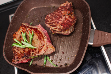 grilled beef steak with vegetables, seasoned with pepper and rosemary, close-up