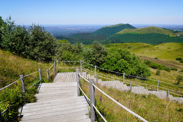 Fototapeta na wymiar wooden staircase for hiking and access to pariou in Puy de Dôme volcano in Auvergne france