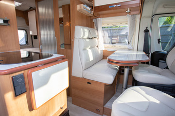 rv Camper Dining Room area with wooden white luxury interior in motor home van during vanlife