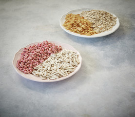 nuts in the plate and up concept, marble grey background.