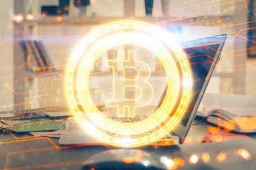 Multi exposure of blockchain theme hologram and table with computer background. Concept of bitcoin...