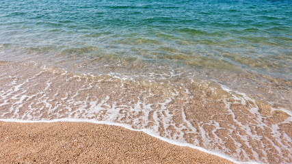 Obraz na płótnie Canvas Сoastal sea waves on a sandy beach.