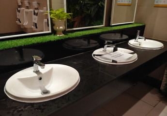 Sink in toilet with Thai text is not used due to social distancing to prevent COVID-19
