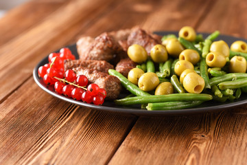 Bean pods, olive and fried Turkish cutlets.