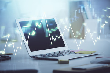 Forex graph hologram on table with computer background. Multi exposure. Concept of financial markets.