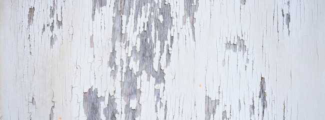 old white cracked paint on vertical wooden planks