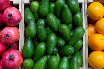 Juicy fruits of tropical avocados, oranges and pomegranates.