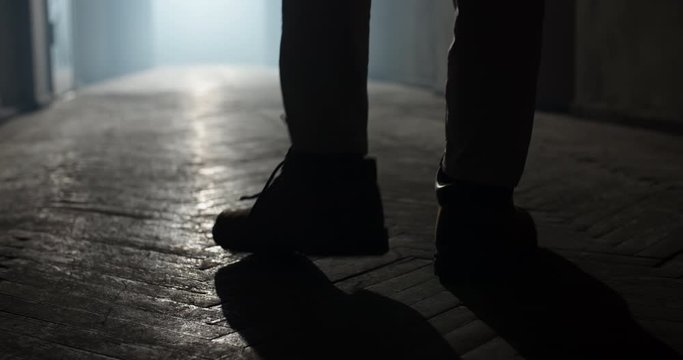 Maniac carrying a murderous weapon escaping from crime scene. Bloodthisty criminal carrying an axe in hallway of old house 4k footage