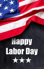 Fototapeta na wymiar Happy Labor Day text and USA flag on black color background