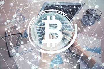 Blockchain theme hologram with man working on computer on background. Concept of crypto chain. Double exposure.