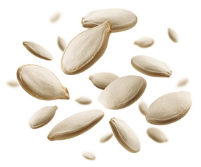 Pumpkin seeds levitate on a white background