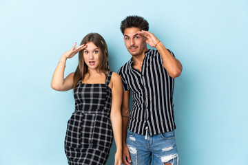 Teenager caucasian couple isolated on blue background has just realized something and has intending the solution
