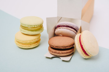 Several colorful macaroon cakes on a colored background