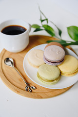 Several colorful macaroon cakes on a colored background