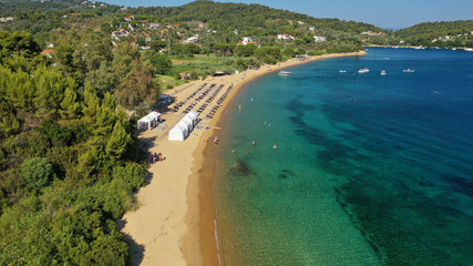 Fototapeta na wymiar Aerial drone photo of famous organised with sun beds and umbrellas sandy beach of Agia Paraskevi in island of Skiathos, Sporades, Greece