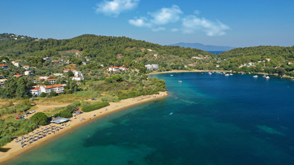 Fototapeta na wymiar Aerial drone photo of famous organised with sun beds and umbrellas sandy beach of Agia Paraskevi in island of Skiathos, Sporades, Greece