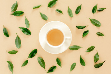 Cup of fresh green tea with tea leaves. Flat lay, top view. Tea concept