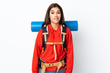 Young caucasian mountaineer girl with a big backpack isolated on white background having doubts and with confuse face expression