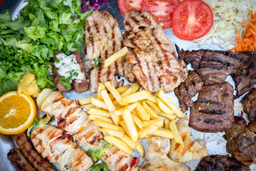Family siyed portion of meat and chicken served on a plate
