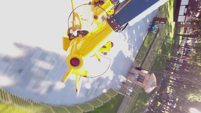 attraction of spinning, flying planes in the amusement park. first person video.