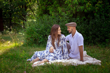 pretty couple in love at the picnic smiles each others