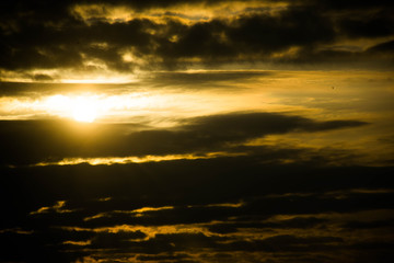 Fototapeta premium Thunderclouds and the sun is trying to shine through them
