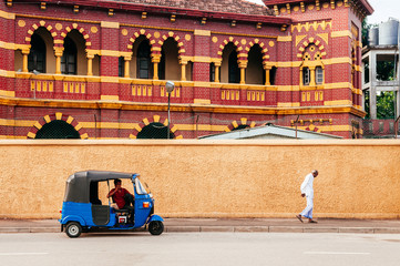 Victoria Memorial Building and auto rickshaw or Bajaj three wheeler on street in Colombo, Sri Lanka - 371163353
