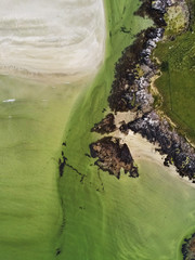 Aerial top down view on a coast line, West of Ireland. Green fields and rock stone coast line. Nobody.