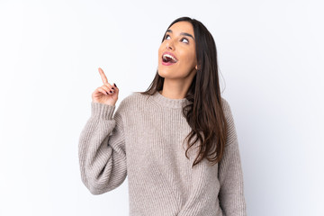 Young brunette woman over isolated white background intending to realizes the solution while...