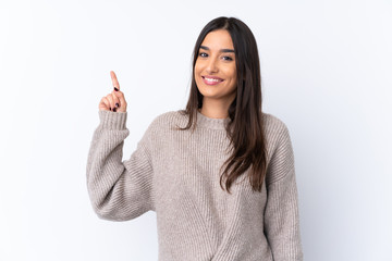 Young brunette woman over isolated white background showing and lifting a finger in sign of the best