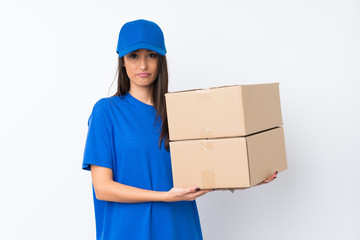 Young delivery woman over isolated white background pleading