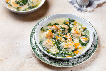 Italian wedding soup with meatballs and ptitim paste