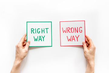 Choice concept. Right and wrong way icons, female hands top view