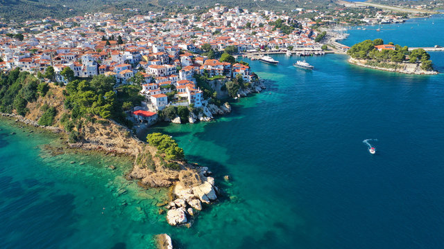 Aerial drone panoramic photo of picturesque main town of Skiathos island featuring small landmark peninsula of Bourtzi, Sporades, Greece