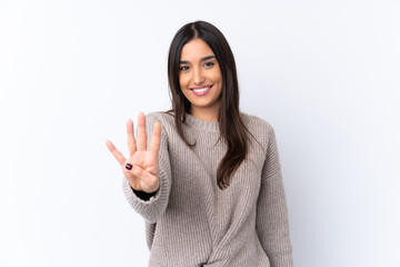 Young brunette woman over isolated white background happy and counting four with fingers