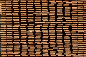 worked wooden boards stacked in a sawmill near Brunico. south tyrol, italy.
